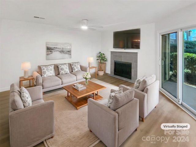 5003 Sharon Rd Unit S, Charlotte, NC 28210 - living area featuring wood finished floors, a tile fireplace, and ceiling fan