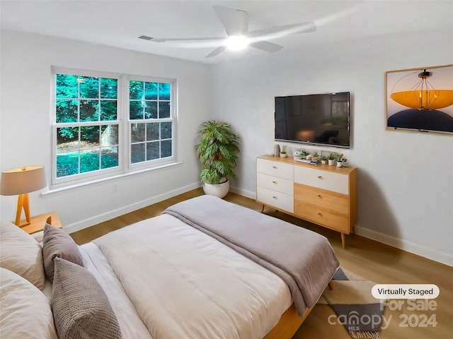 bedroom featuring hardwood / wood-style floors and ceiling fan