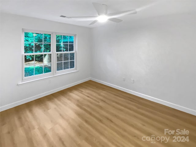 spare room with wood-type flooring and ceiling fan