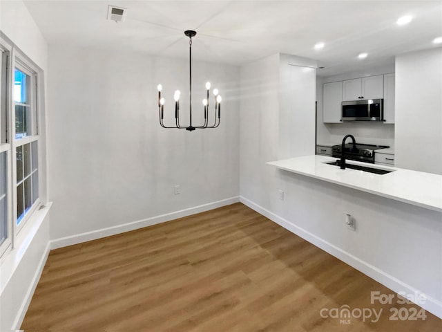 5003 Sharon Rd Unit S, Charlotte, NC 28210 - unfurnished dining area featuring light wood finished floors, baseboards, a chandelier, recessed lighting, and a sink