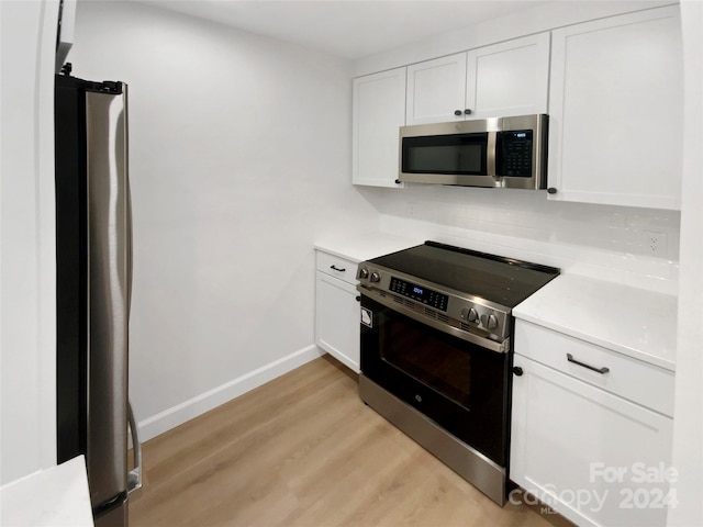 kitchen featuring light hardwood / wood-style flooring, white cabinets, and appliances with stainless steel finishes