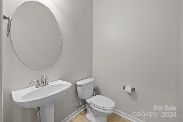 bathroom featuring sink, tile patterned flooring, and toilet