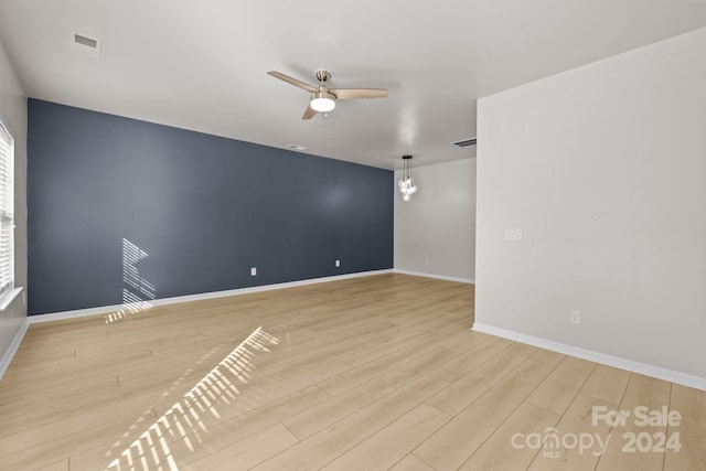 spare room featuring ceiling fan and light hardwood / wood-style flooring