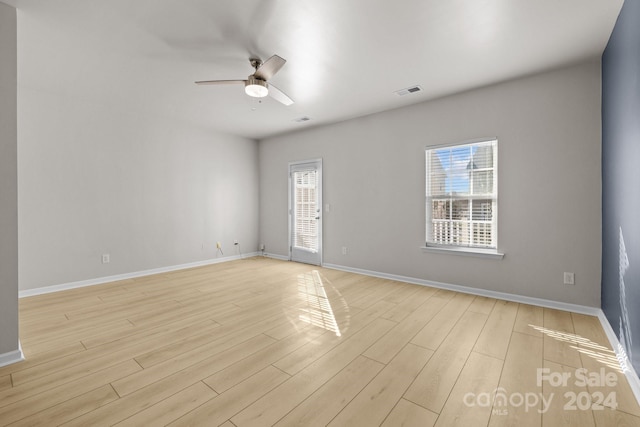 empty room with light wood-type flooring and ceiling fan