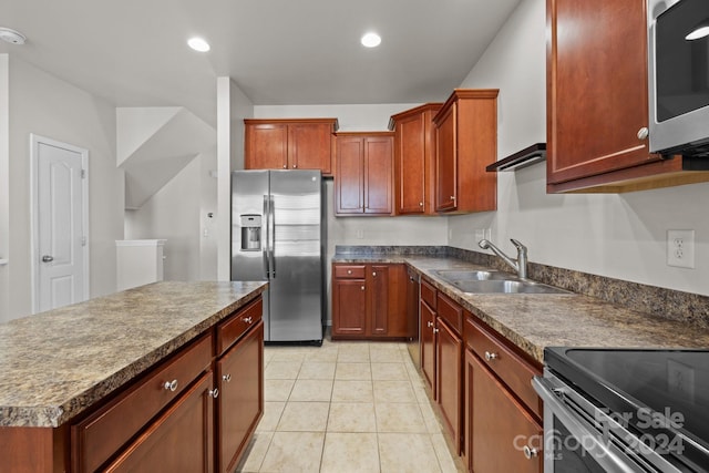 kitchen with light tile patterned floors, sink, and appliances with stainless steel finishes