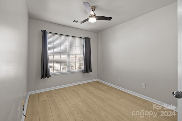 spare room featuring light wood-type flooring and ceiling fan