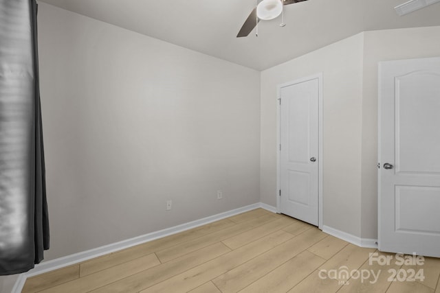 unfurnished bedroom featuring light wood-type flooring and ceiling fan