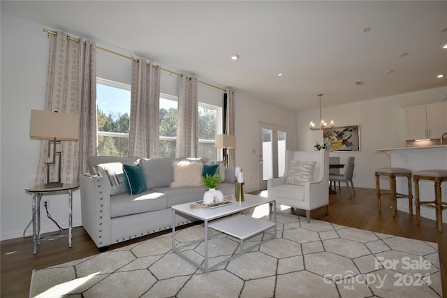 living room with hardwood / wood-style flooring and a chandelier