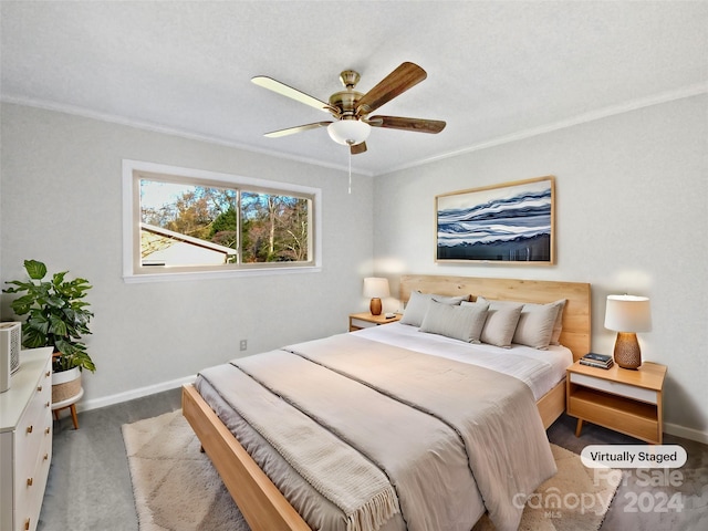 carpeted bedroom featuring ceiling fan and ornamental molding