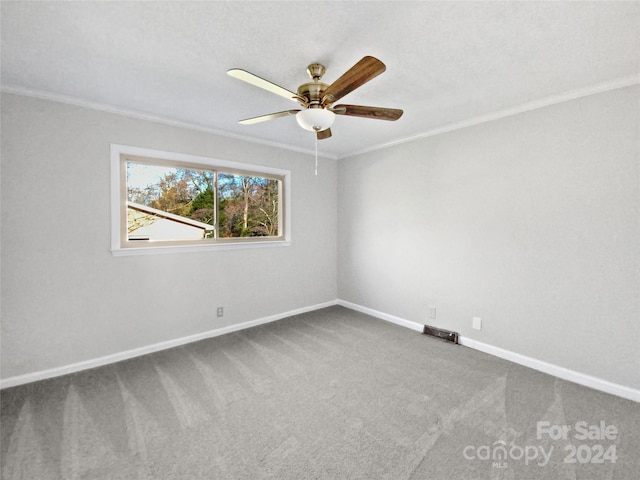 carpeted spare room with ceiling fan and ornamental molding