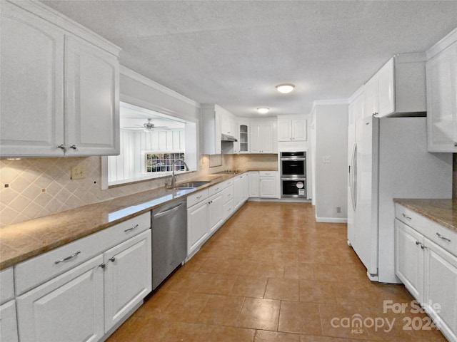 kitchen featuring tasteful backsplash, white cabinetry, sink, and stainless steel appliances