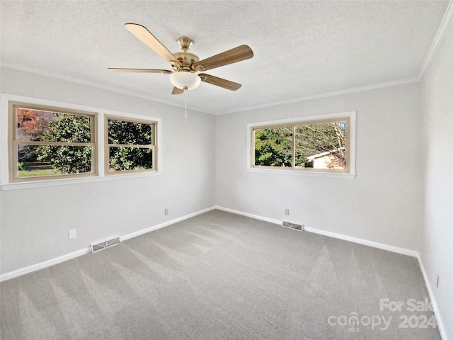 spare room with carpet flooring, crown molding, ceiling fan, and a textured ceiling