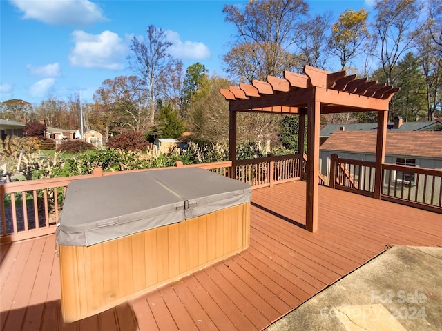 deck featuring a pergola and a hot tub