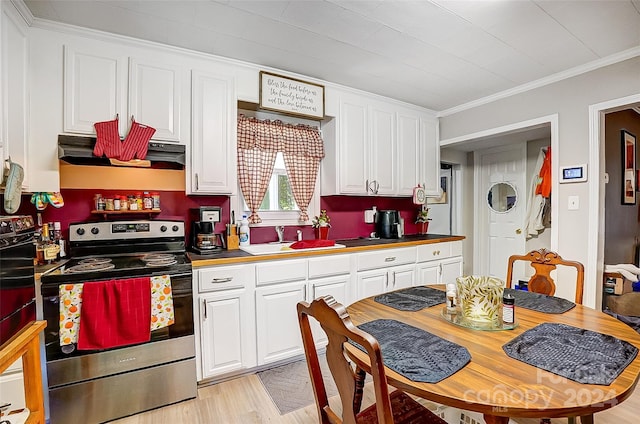 kitchen with light hardwood / wood-style floors, white cabinetry, ornamental molding, and electric stove