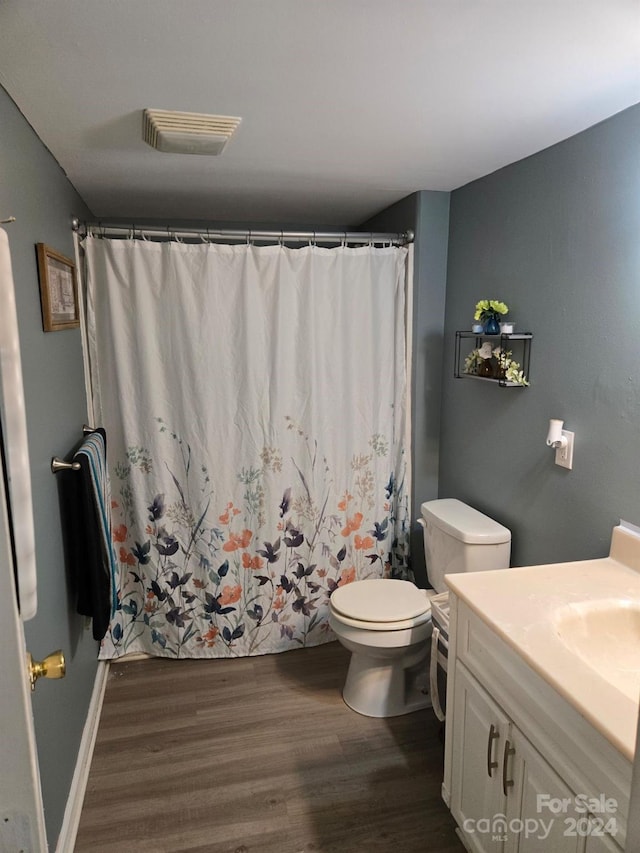 bathroom featuring hardwood / wood-style flooring, vanity, and toilet