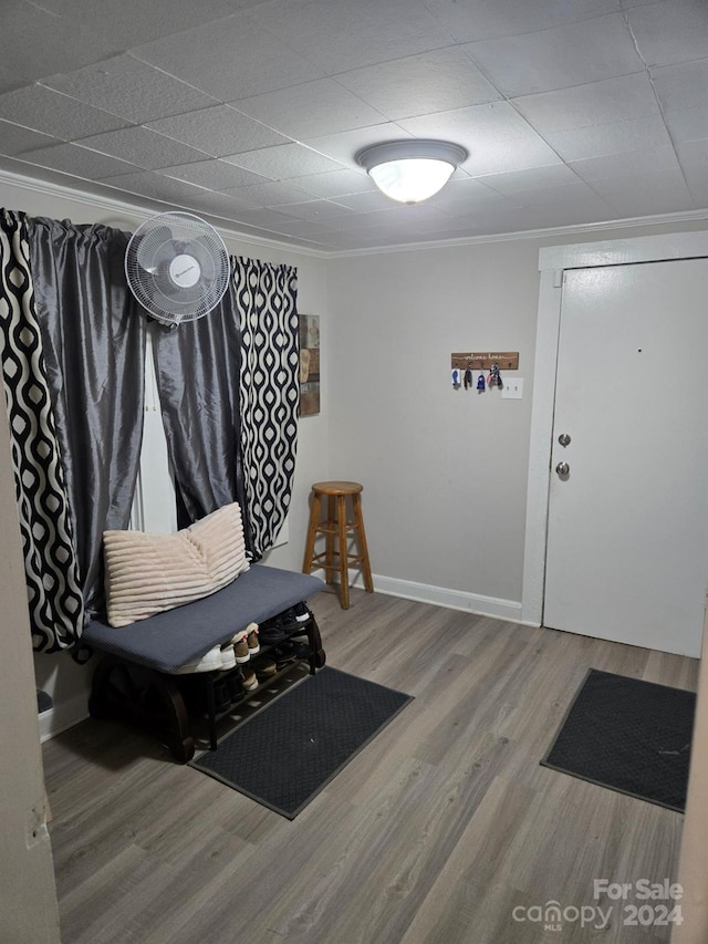 interior space featuring hardwood / wood-style flooring and ornamental molding