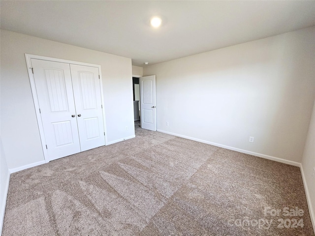 unfurnished bedroom featuring a closet and carpet