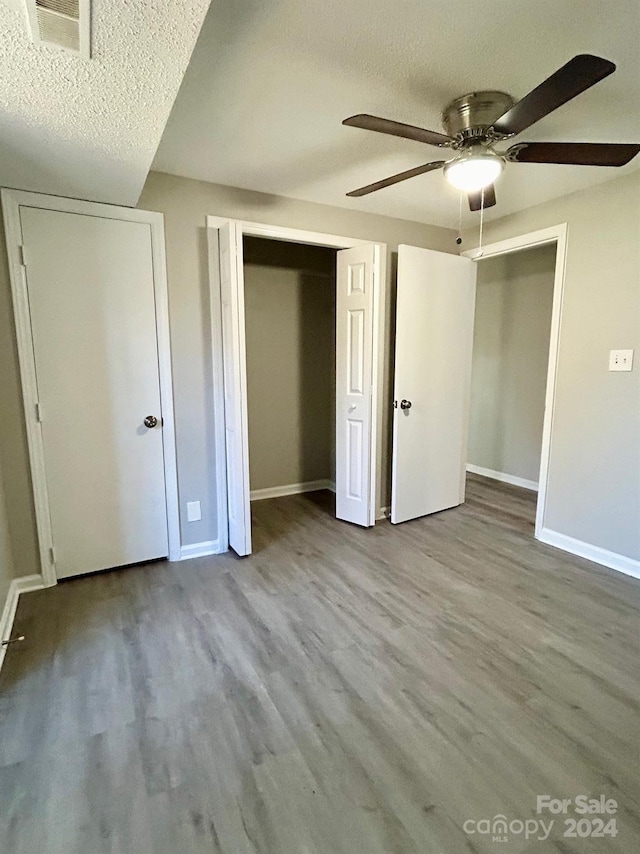 unfurnished bedroom with ceiling fan, light wood-type flooring, and a textured ceiling