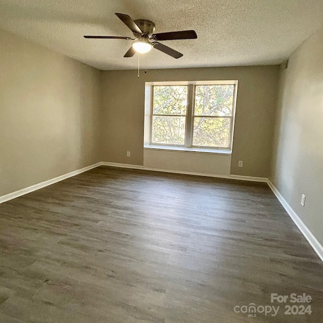 unfurnished room with a textured ceiling, ceiling fan, and dark hardwood / wood-style floors