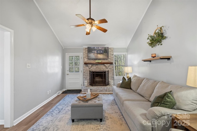 living room with a brick fireplace, lofted ceiling, hardwood / wood-style flooring, and ceiling fan