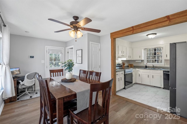 dining room with ceiling fan and sink