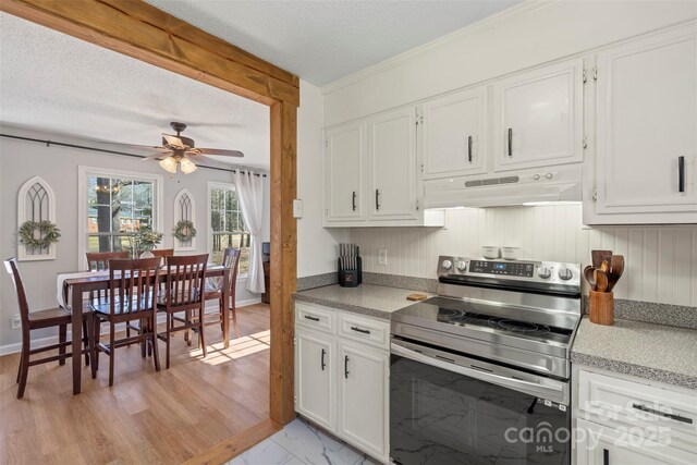 kitchen with ceiling fan, white cabinets, stainless steel electric range oven, and a textured ceiling