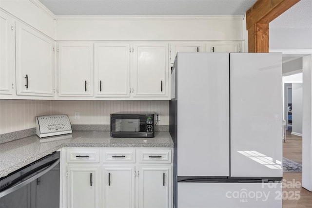 kitchen featuring black appliances, white cabinetry, and ornamental molding