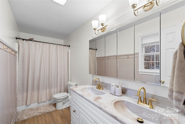 full bathroom featuring toilet, vanity, shower / bath combination with curtain, and hardwood / wood-style flooring