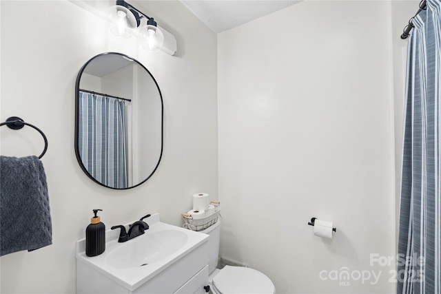 bathroom featuring toilet and vanity