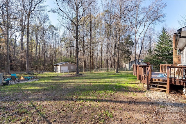 view of yard with a wooden deck and a shed