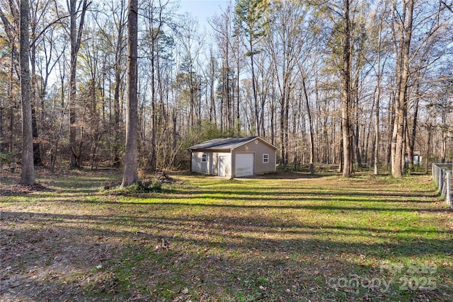 view of yard featuring an outbuilding and a garage