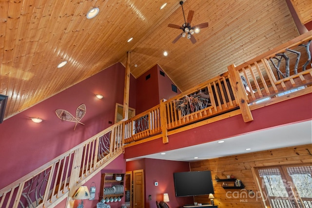 stairs featuring ceiling fan, high vaulted ceiling, and wooden ceiling