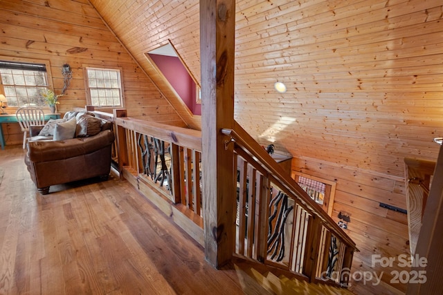 bonus room featuring wood-type flooring, wooden walls, vaulted ceiling, and wooden ceiling