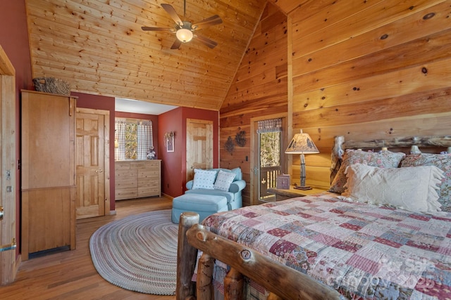 bedroom with ceiling fan, lofted ceiling, wooden walls, wood ceiling, and light wood-type flooring