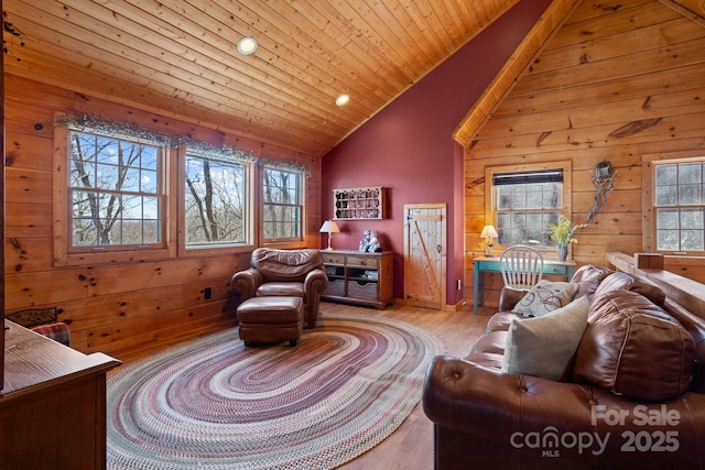 living room featuring wooden walls, light hardwood / wood-style flooring, and wood ceiling