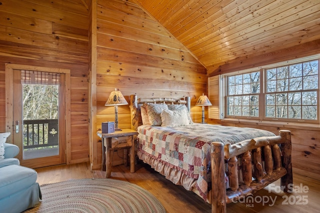 bedroom with access to exterior, wood ceiling, wooden walls, wood-type flooring, and lofted ceiling