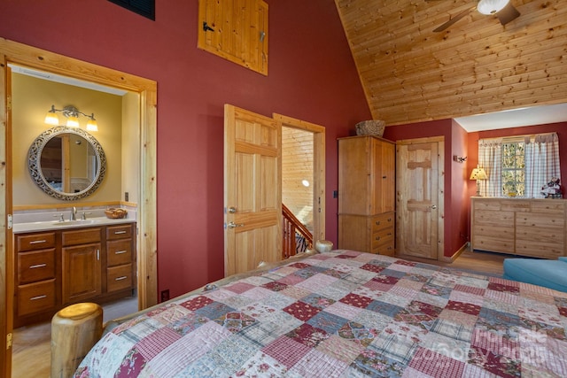 bedroom with ensuite bath, sink, wood ceiling, and vaulted ceiling