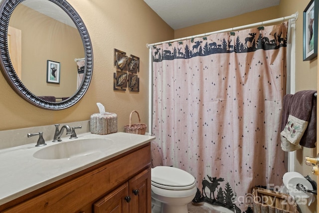 bathroom with a shower with curtain, vanity, and toilet