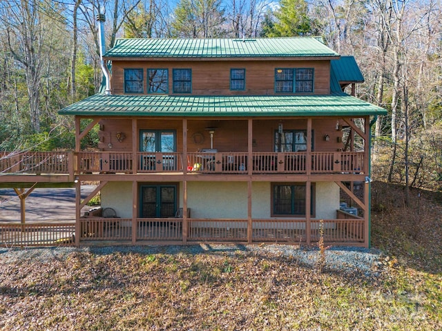 back of house featuring a deck and french doors