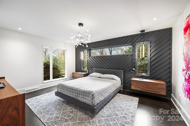 bedroom featuring dark hardwood / wood-style floors and a notable chandelier