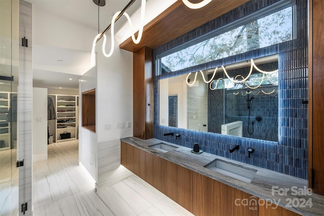 bathroom featuring backsplash, vanity, and a shower with shower door