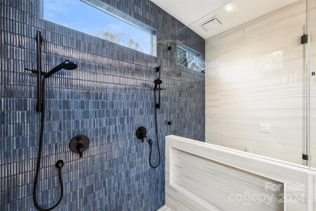 bathroom with a tile shower