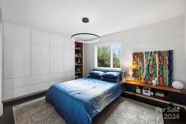 bedroom with hardwood / wood-style flooring