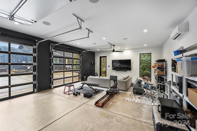 garage featuring a wall mounted AC and ceiling fan