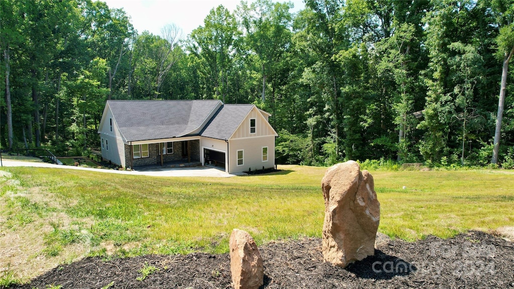 view of front of property with a garage and a front lawn