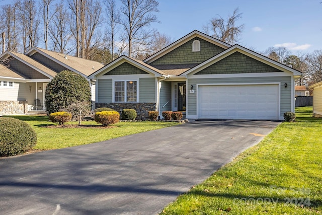 craftsman-style home with a front lawn and a garage