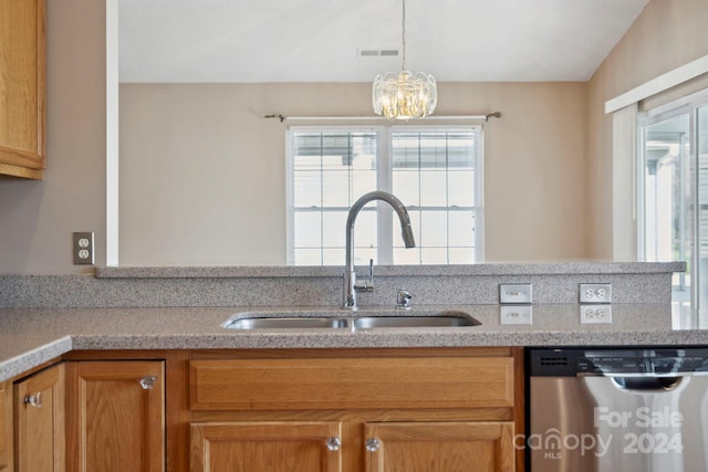 kitchen with pendant lighting, dishwasher, sink, vaulted ceiling, and a chandelier