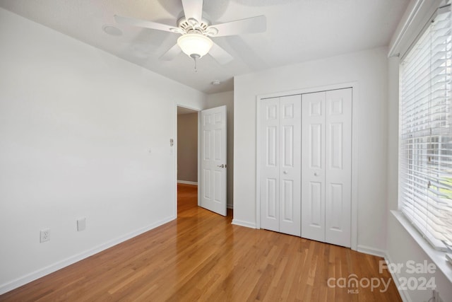 unfurnished bedroom featuring a closet, ceiling fan, and light hardwood / wood-style floors