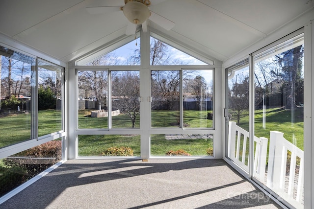 unfurnished sunroom with ceiling fan, lofted ceiling, and a wealth of natural light