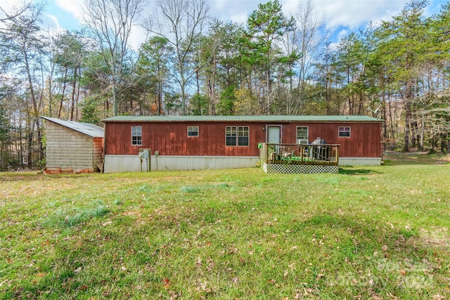 back of house with a lawn and a wooden deck